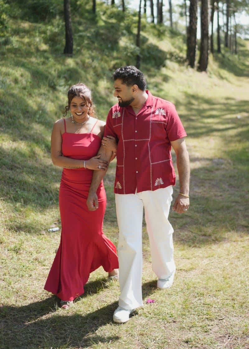 Samriti and Sarthak walking arm in arm on a forest path